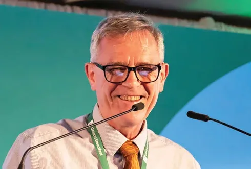 Marc Burban speaking at an insurance industry event.