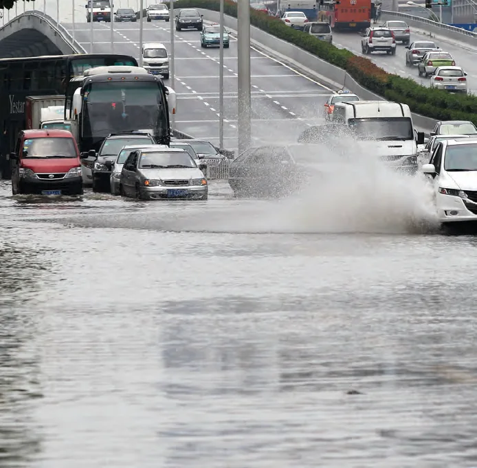Vehicles moving through deep floodwater, illustrating catastrophe response and infrastructure disruption.
